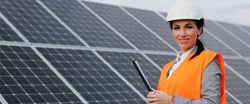 Female engineer in front of solar panels working in the renewable energy industry