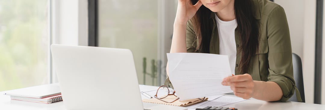 Woman calculating her counteroffer salary thinking about staying at her workplace