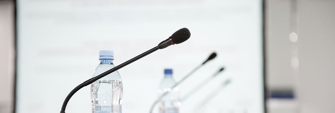 mics on a table at a press conference presentation