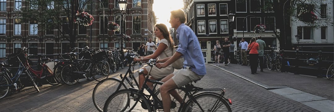 Couple cycling in European city