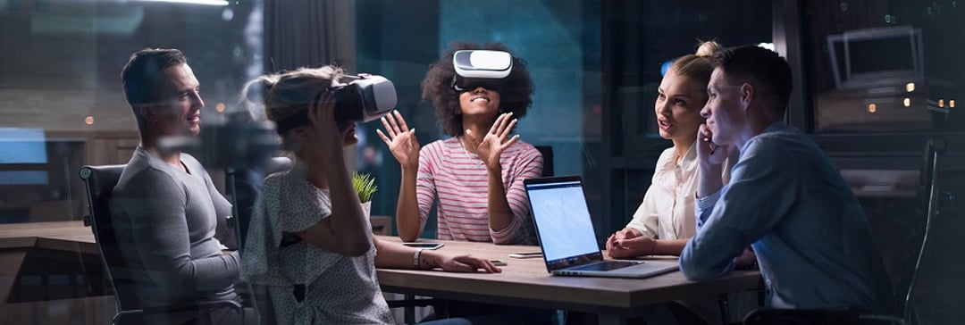 team of office workers using VR in a meeting