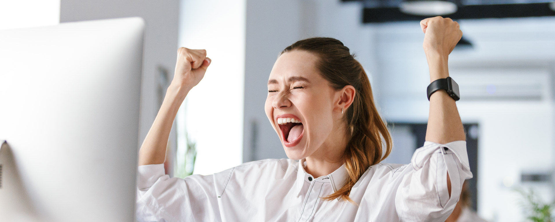 professional woman cheering because she achieved career goals 