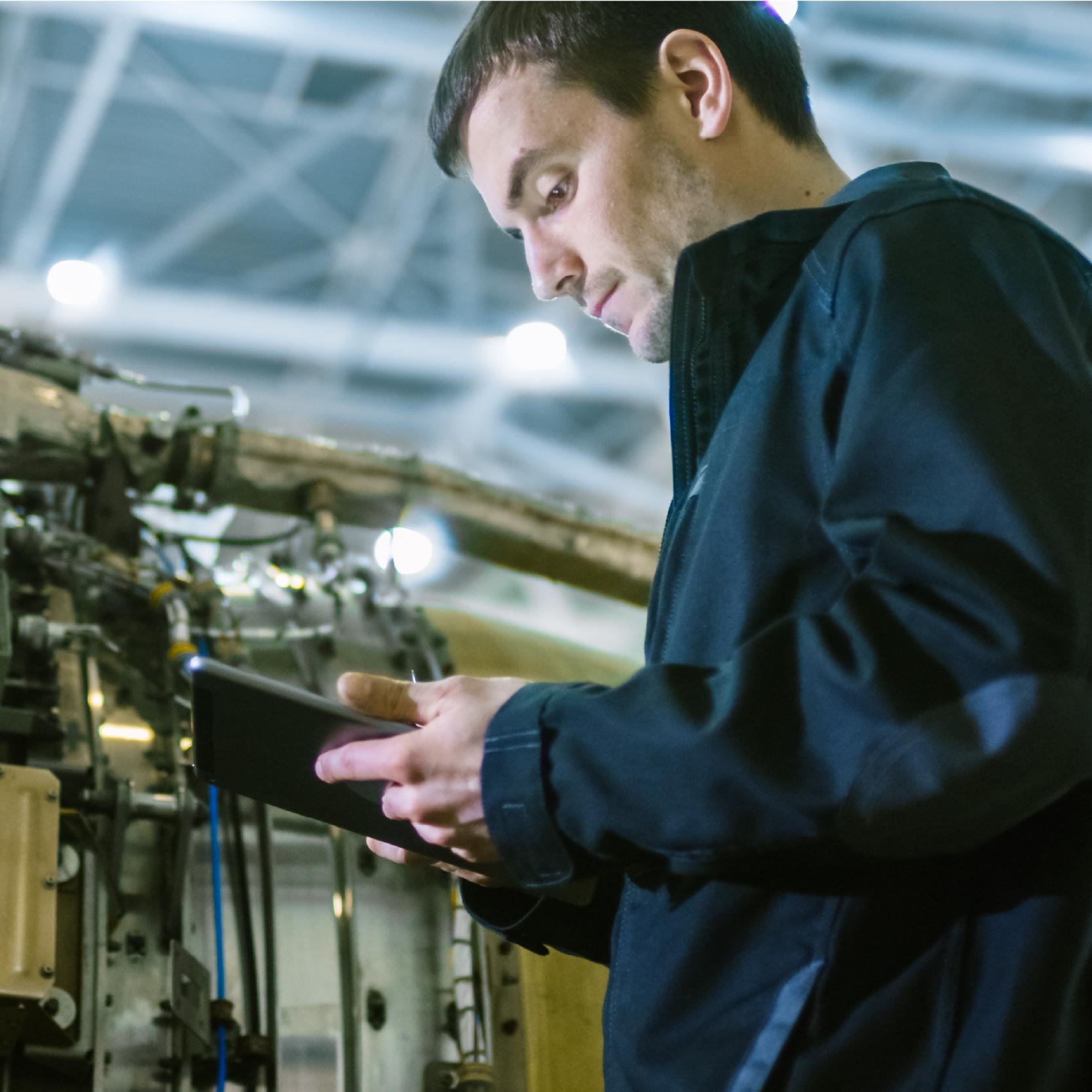 turbine engineer in hangar using technical skills to fix plane