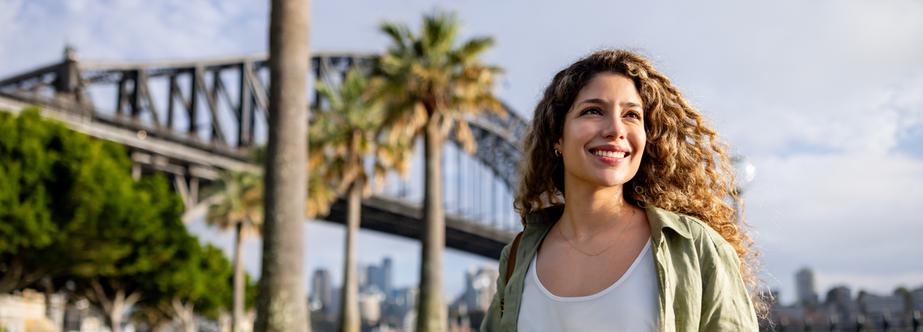 Woman standing in front of Sydney Harbour Bridge
