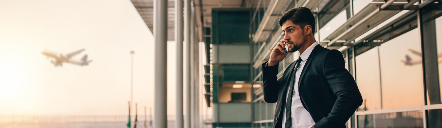 Busy professional using phone at airport