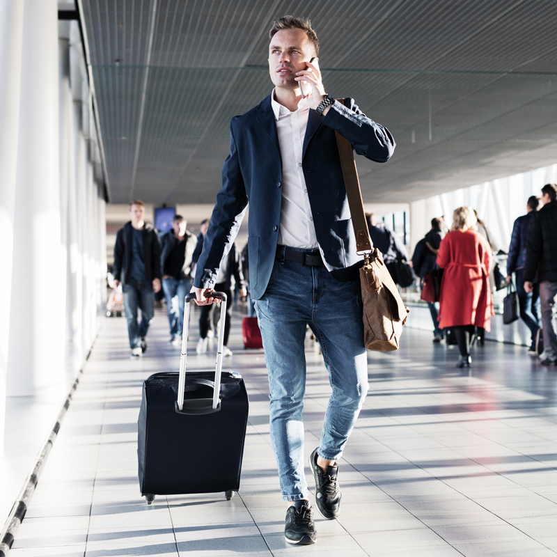 Man using his phone while in transit