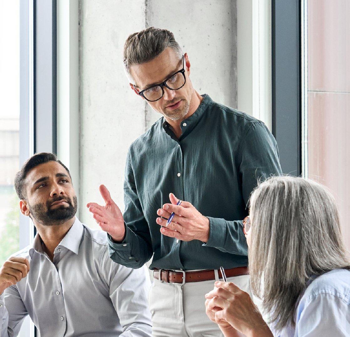Professionals in meeting workshopping strategy with leader