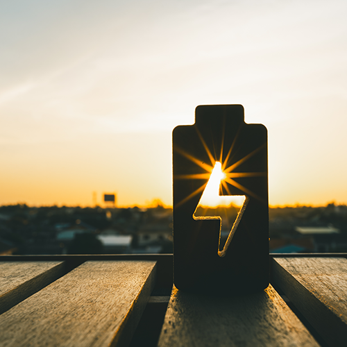 Battery energy symbol at sunrise