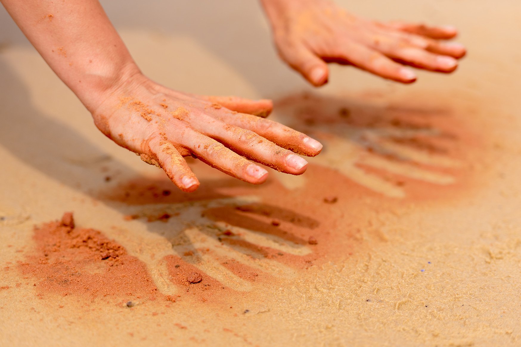 handprints in the sand