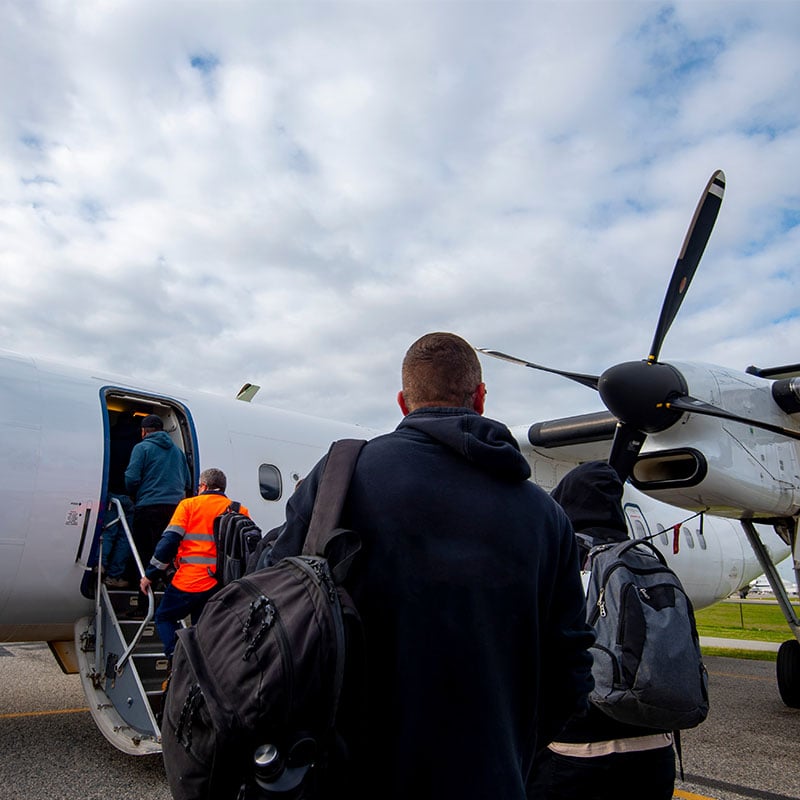 FIFO workers walking to regional airplane to go to site