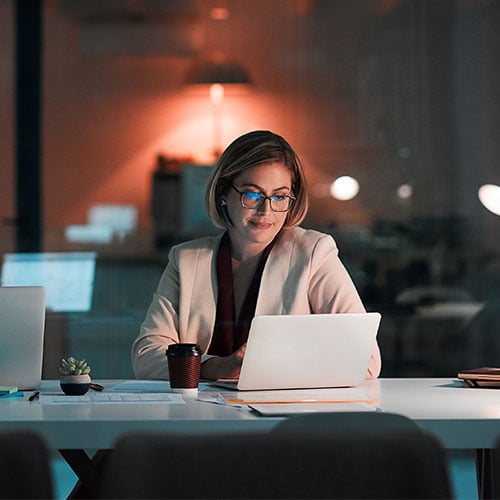 Professional woman working late in office