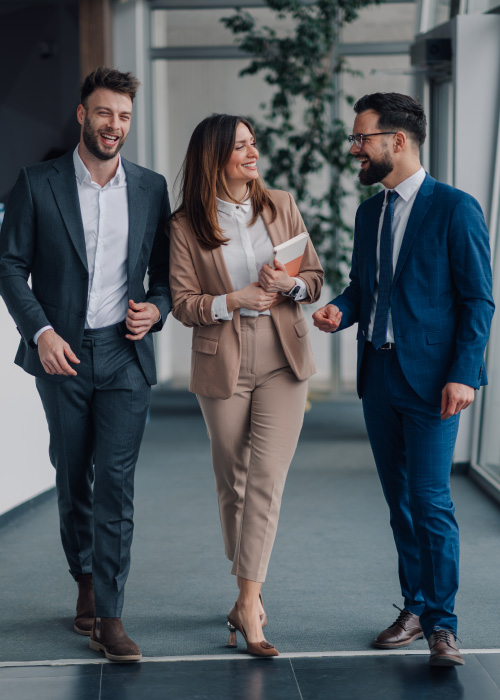 Three executives on their way to a meeting talking