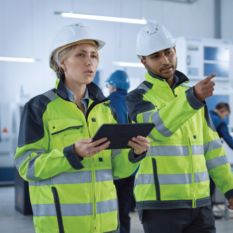 Two engineers in a warehouse talking