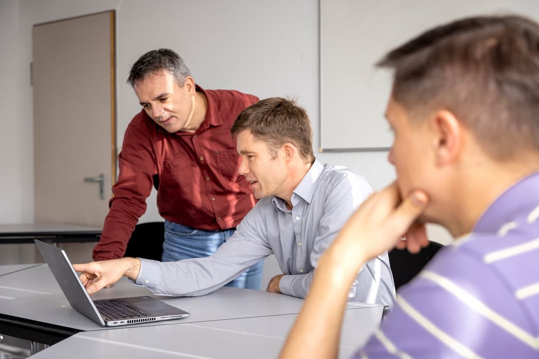 Employees discussing data analysis and software programming project