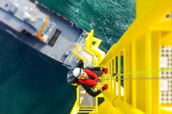 Man climbing ladder offshore