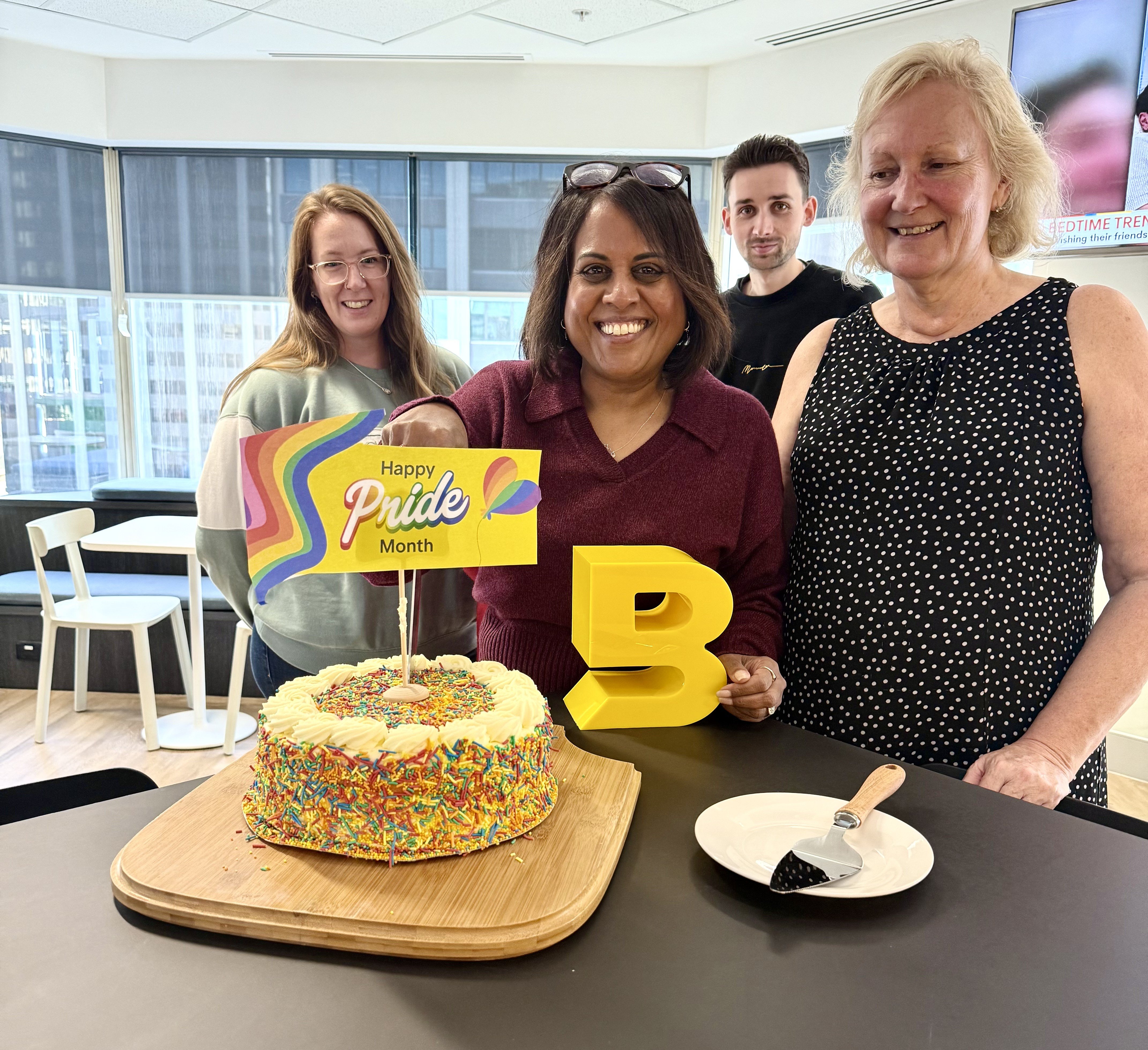 Brunel employees celebrating Pride Month with a rainbow cake and decorations in the office. Brunel employees celebrating Pride Month with a rainbow cake and decorations in the office.