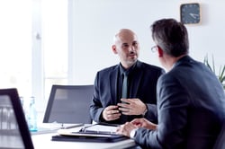 Two men in a suit having a conversation