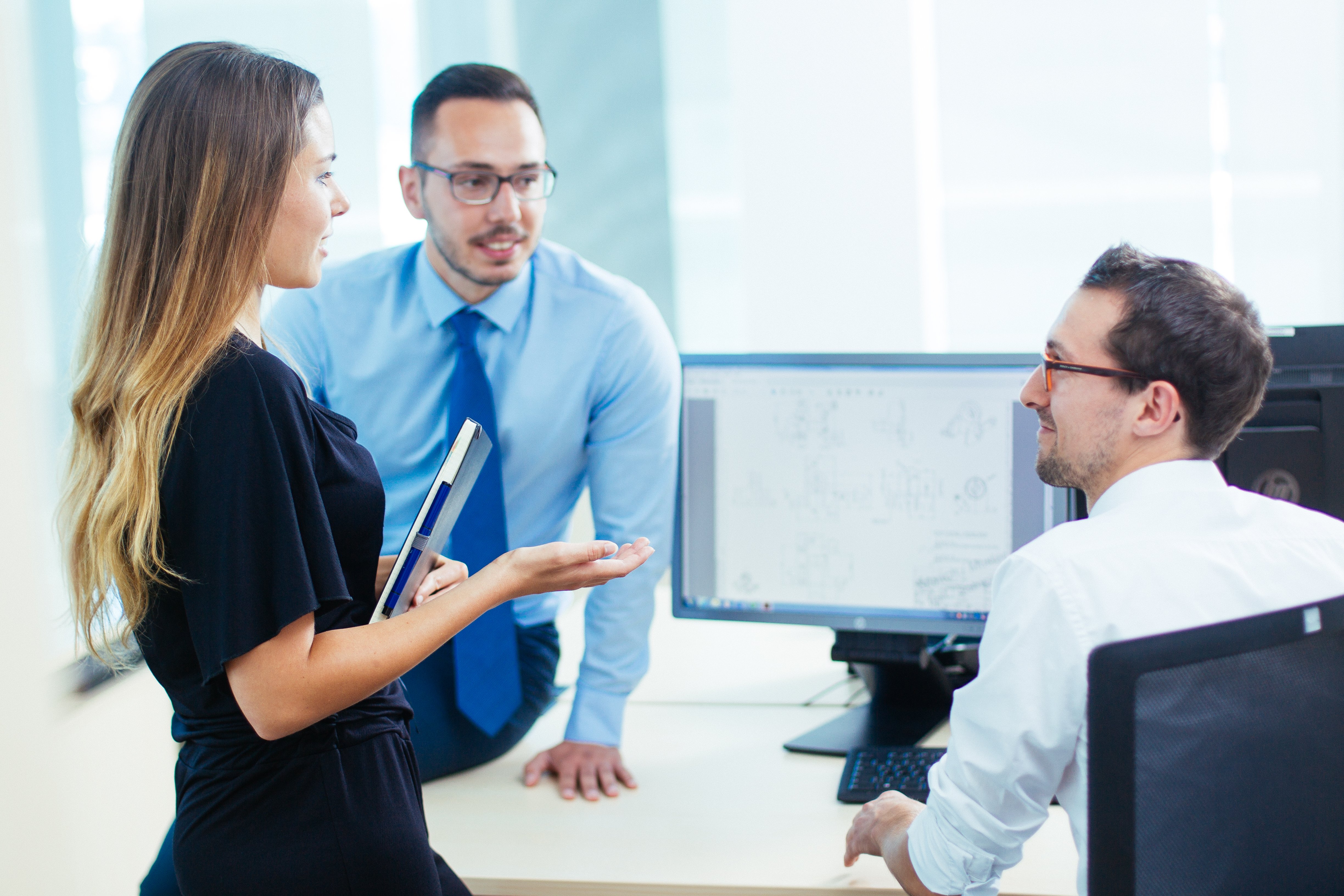 Employees around the desk discussing