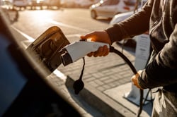 Charger getting plugged in in an electric car