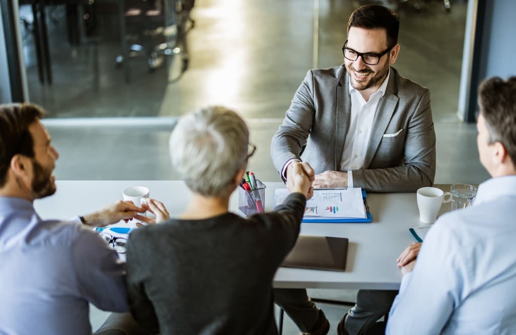 Interviewer shakes candidate's hand during job interview