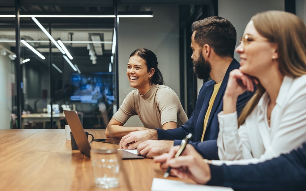 Three professionals collaborating in a meeting