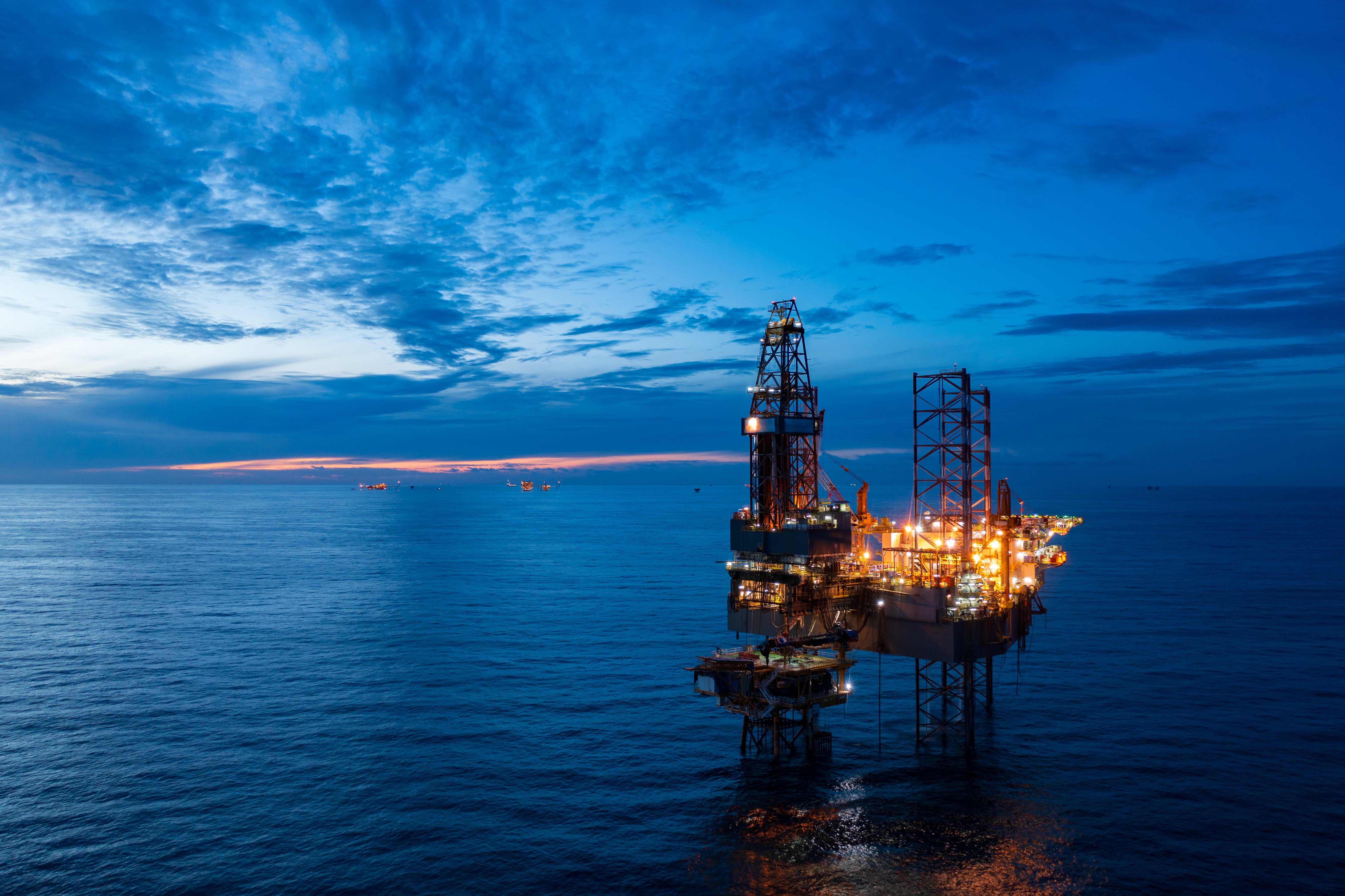 Offshore oil rig operating at sea with offshore rig workers on duty