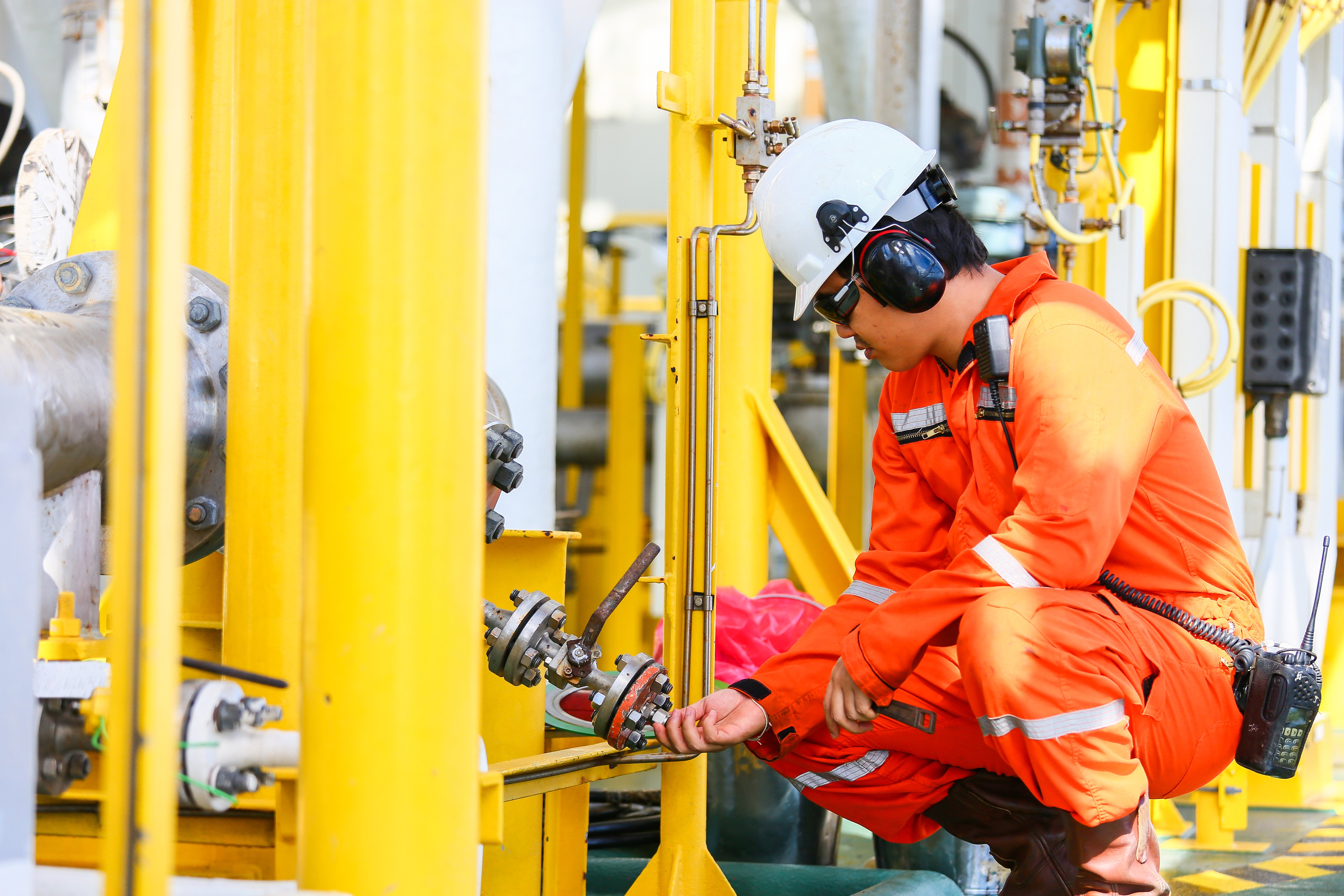 Offshore oil rigger performing maintenance work on an offshore oil platform