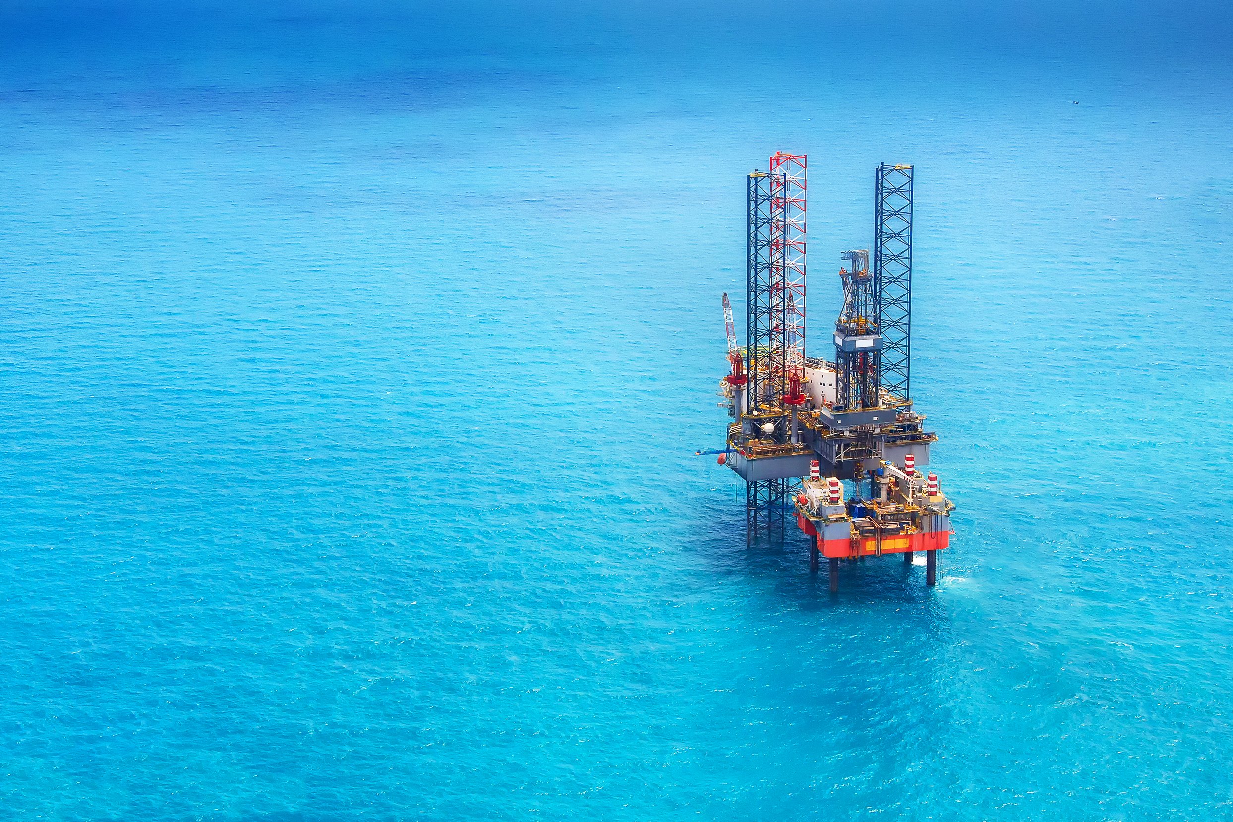 Offshore oil rig located miles from shore, illustrating the remote work environment reached by helicopter during crew changes and offshore rotations.