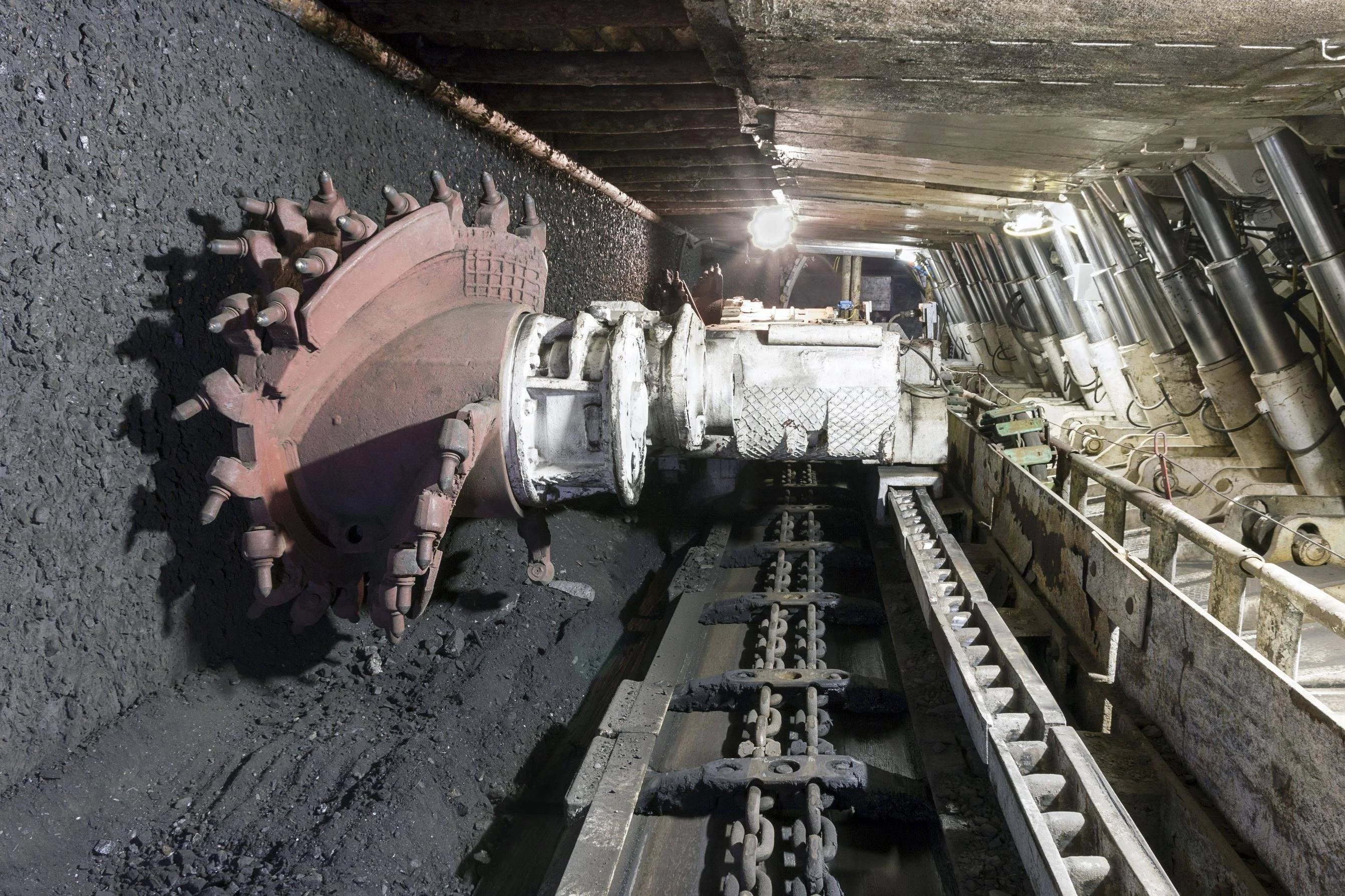 longwall mining equipment including shearer and hydraulic supports in underground subsurface mining operation