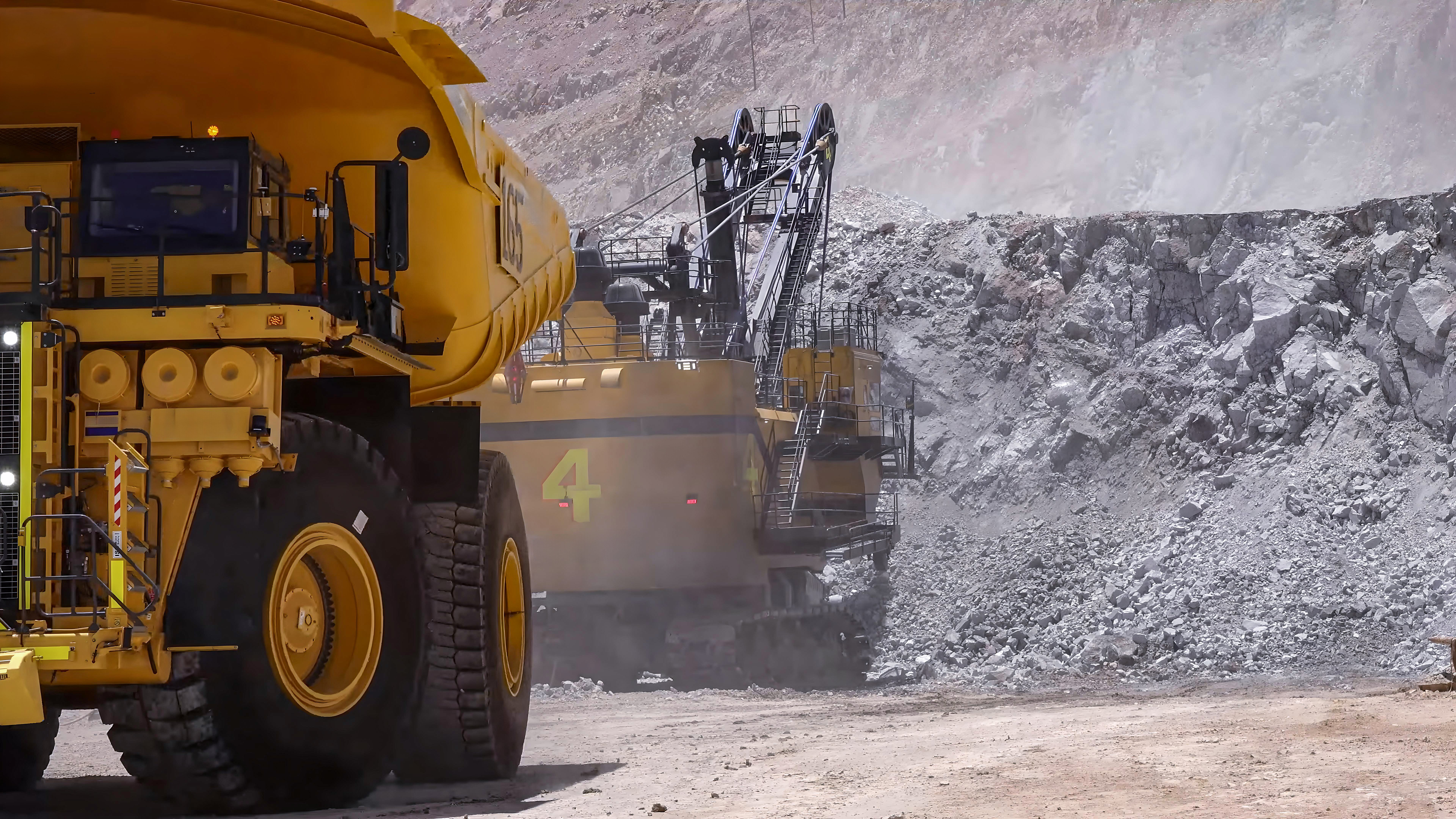large haul truck and excavator used in strip mining surface mining operations removing overburden