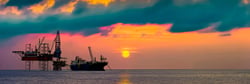 Offshore oil rig and FPSO at sunset