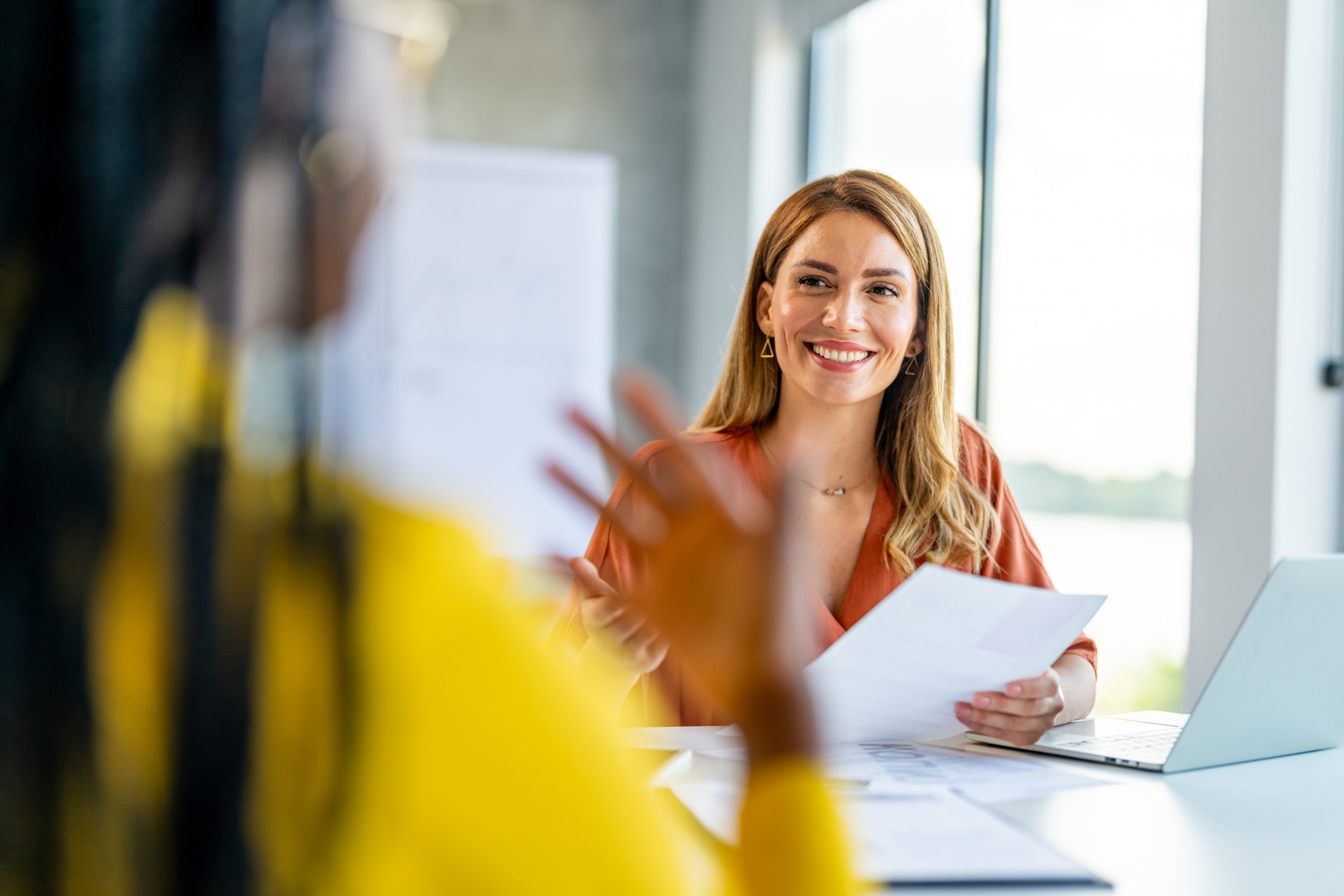 2 Professionals smile as they sit in an interview through Brunel's direct hire services