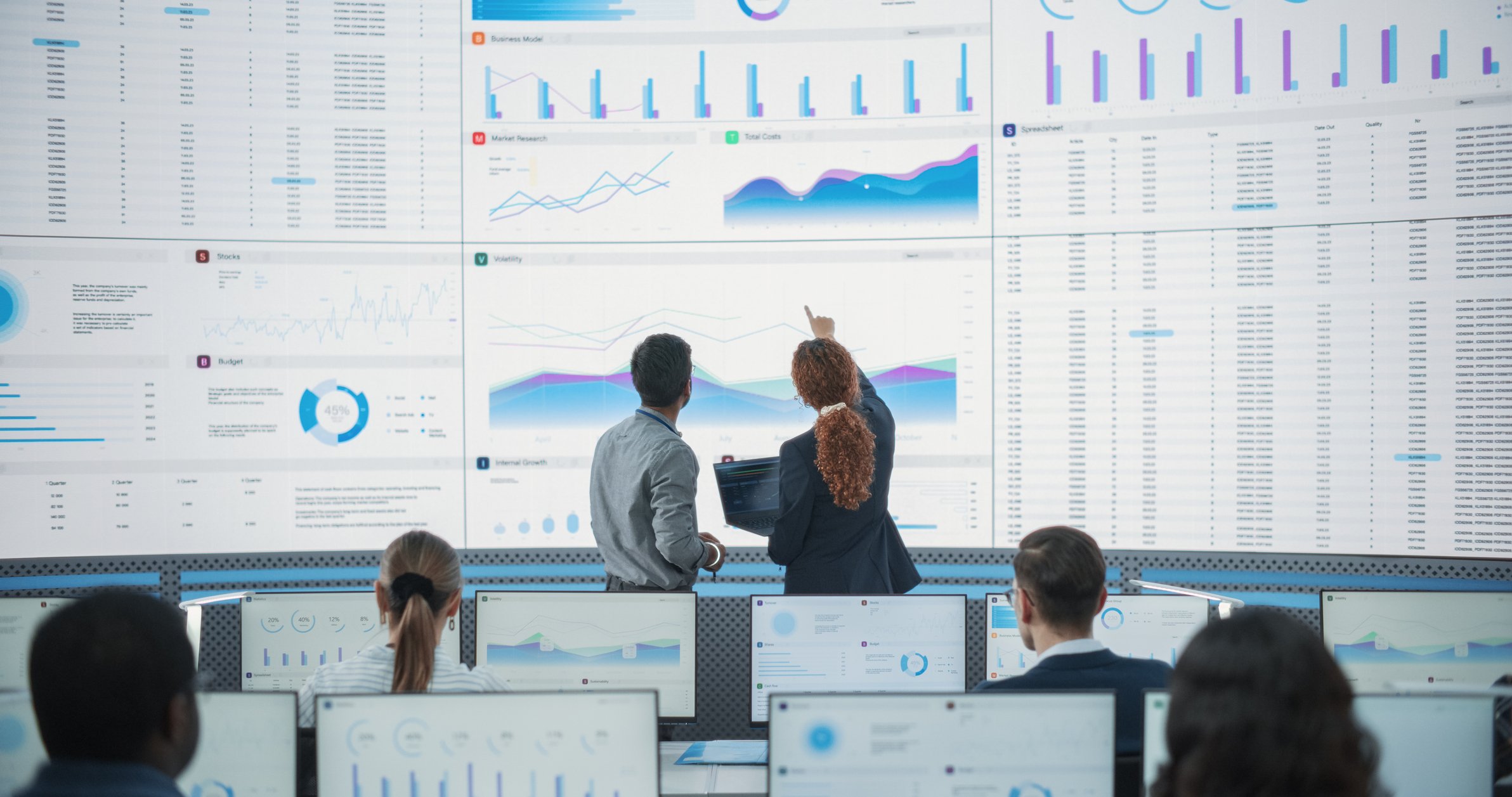 Brunel executive search places COO for growing private equity firm. Photo of a private equity team reviewing data with leadership.