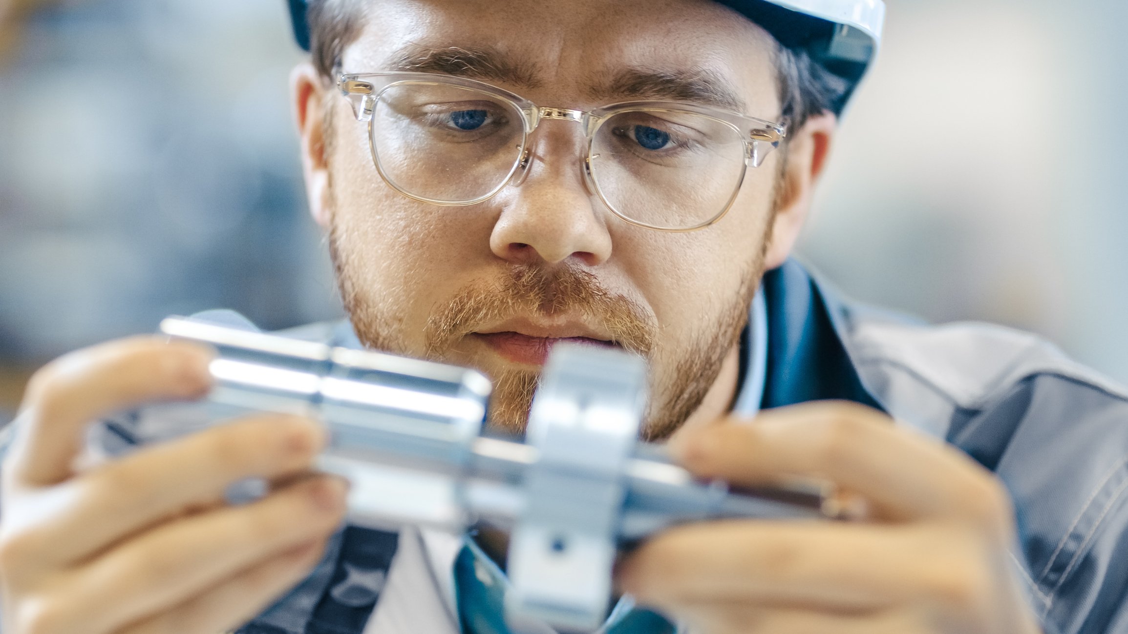Engineer fits two mechanical pieces together, similar to how Brunel Technical Staffing matches top candidates with leading organizations across arious industries