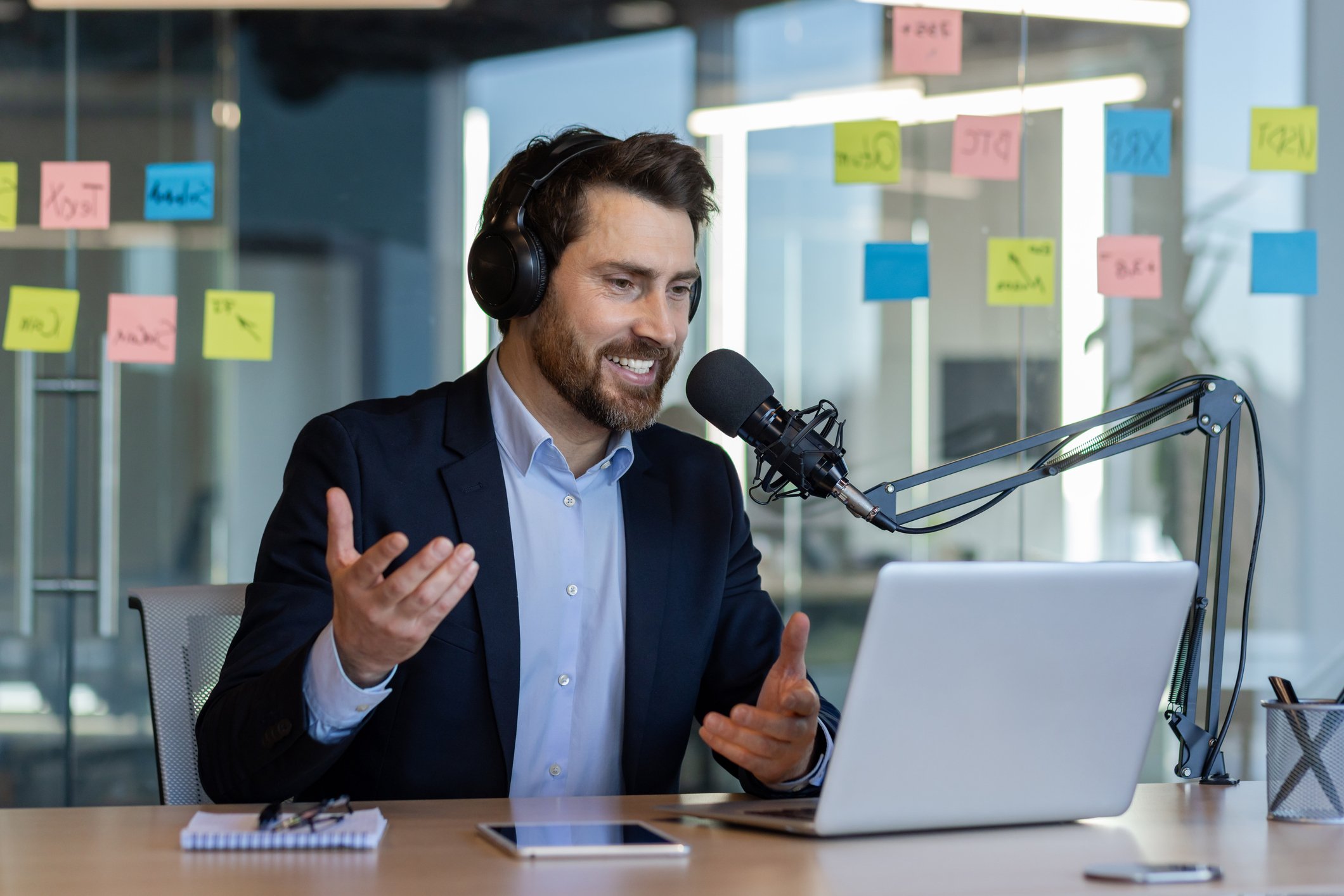 Male sits in office as he contributes to podcasts for professional development