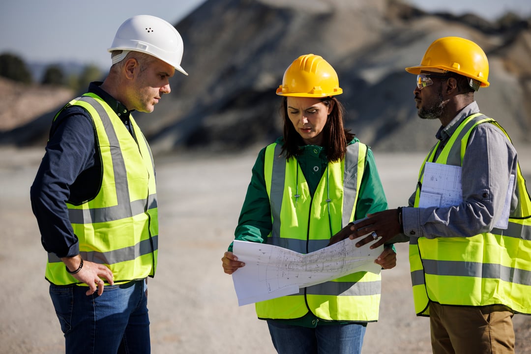 Mining professionals discussing project plans and safety measures.