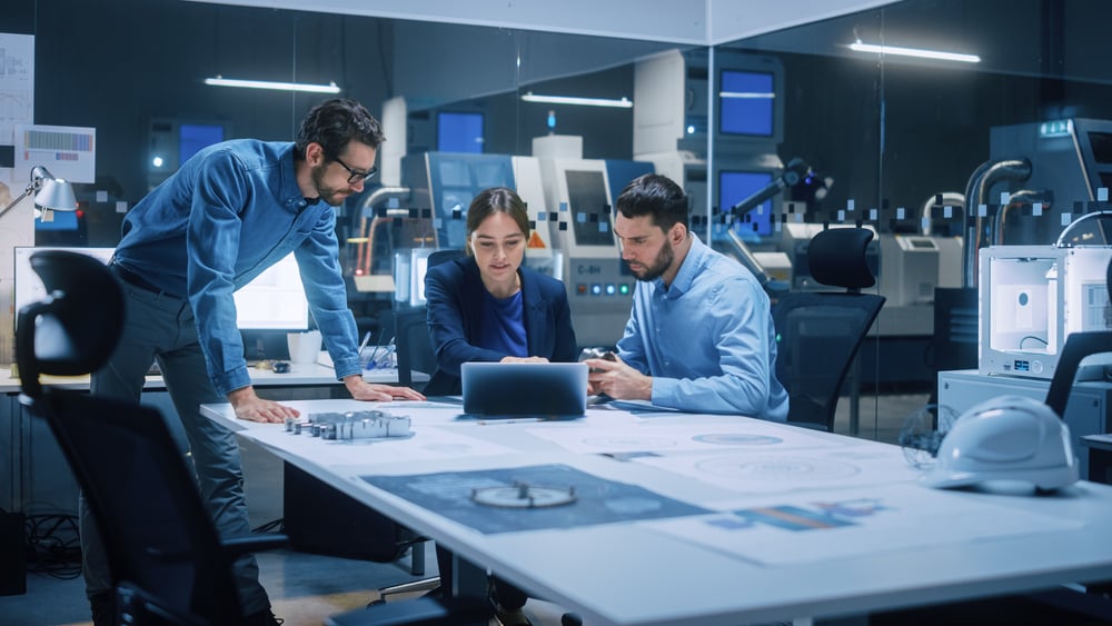 Team of industrial engineers work around a table