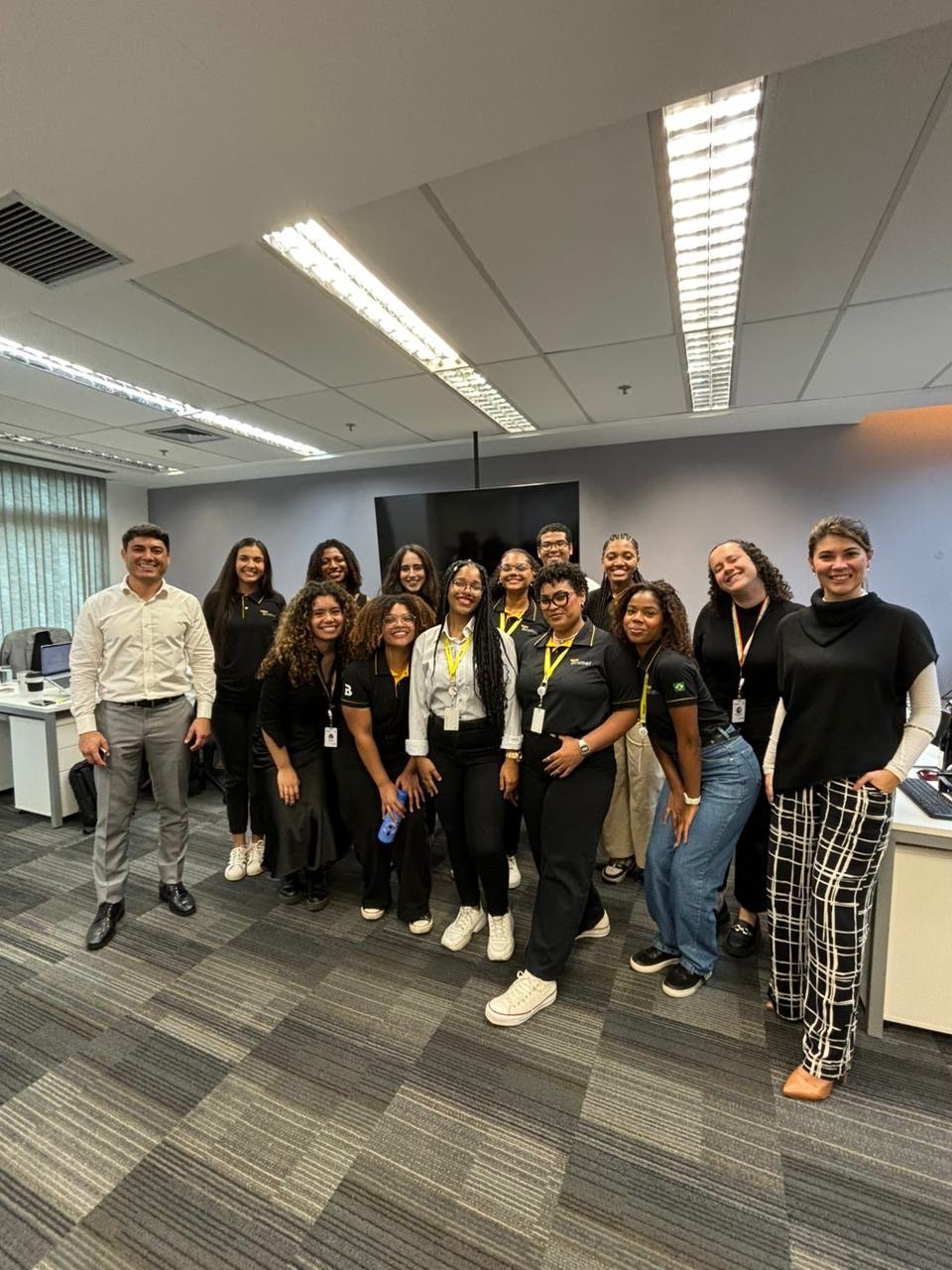 The Young Apprentice program members line up for a picture in the office as they prepare to start their first day learning about recruitment in Brazil