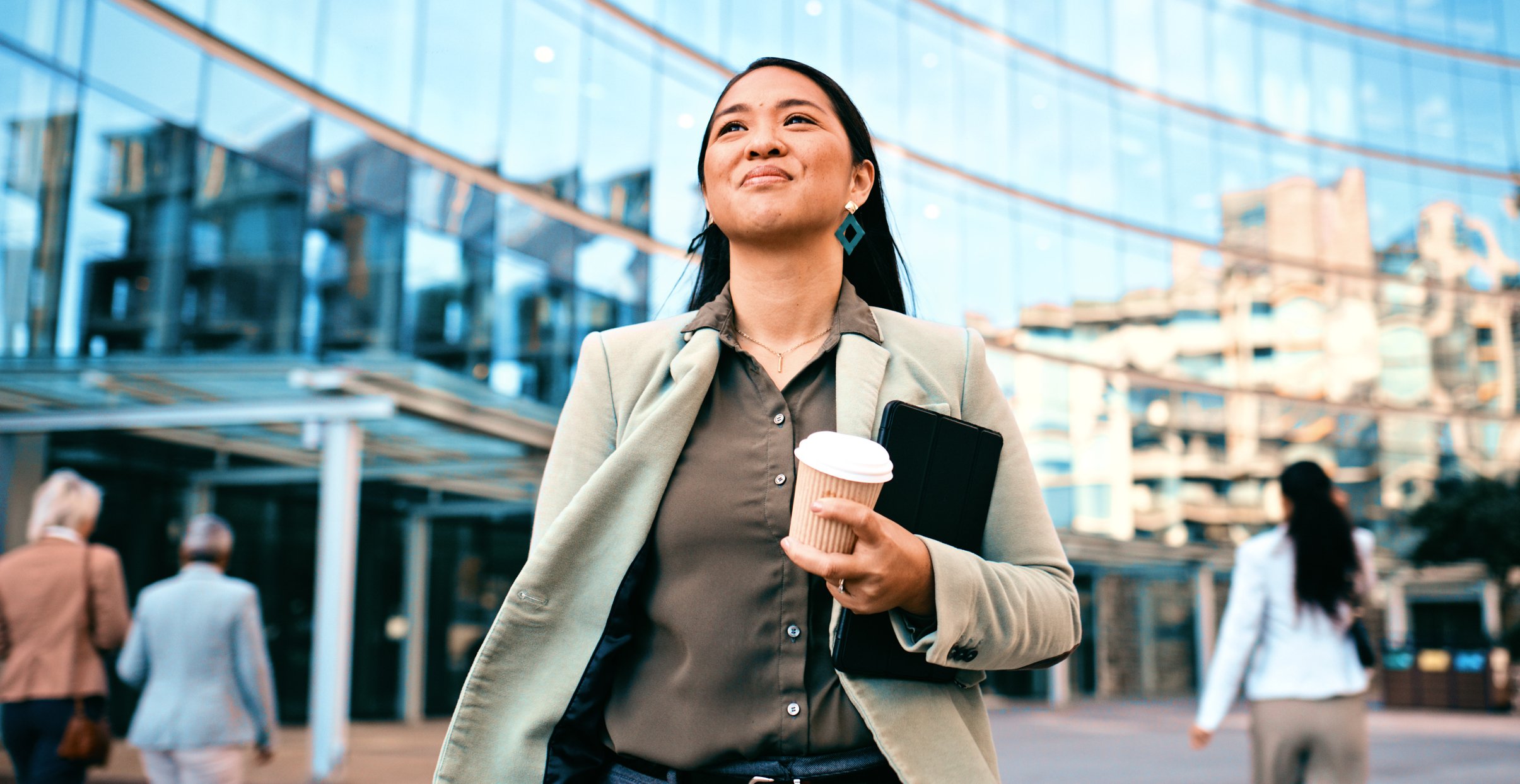 Woman walks with coffee in hand