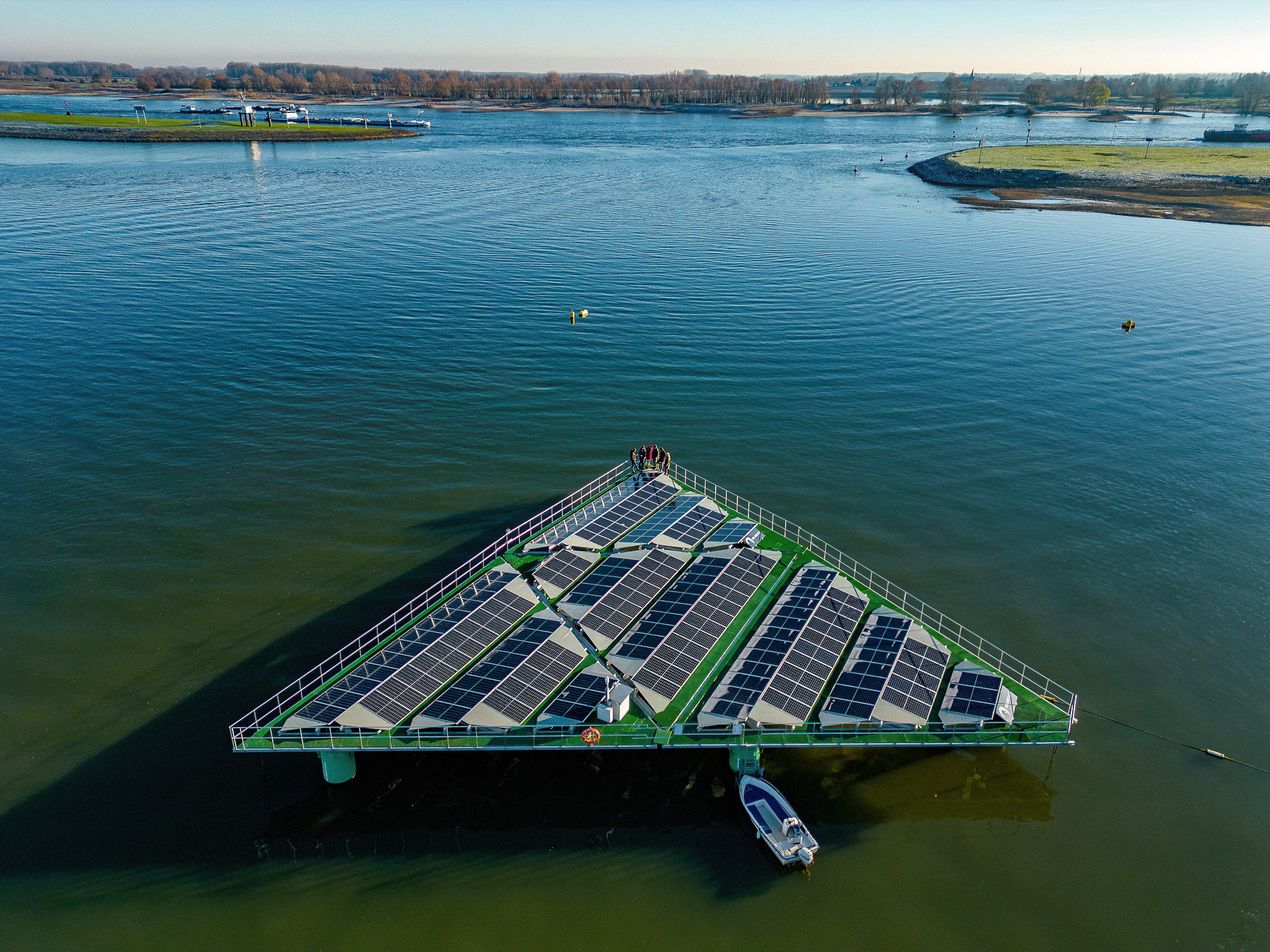 A triangular-shaped floating solar platform installed on a lake to generate renewable energy