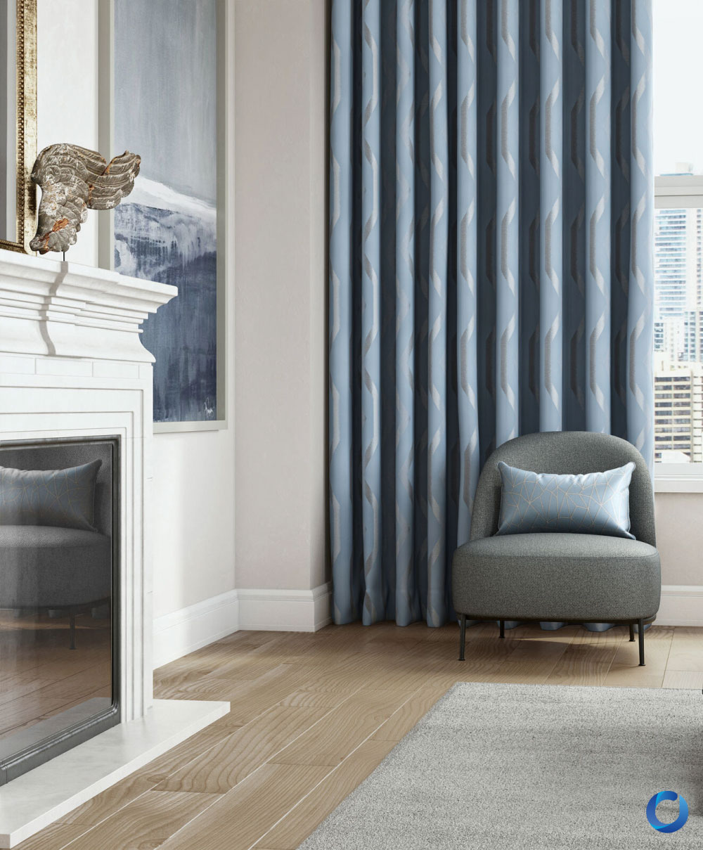 Modern interior with light wood flooring, blue patterned curtains, a gray armchair, and a decorative pillow. The space is accented by a white fireplace, abstract artwork, and soft, natural light.