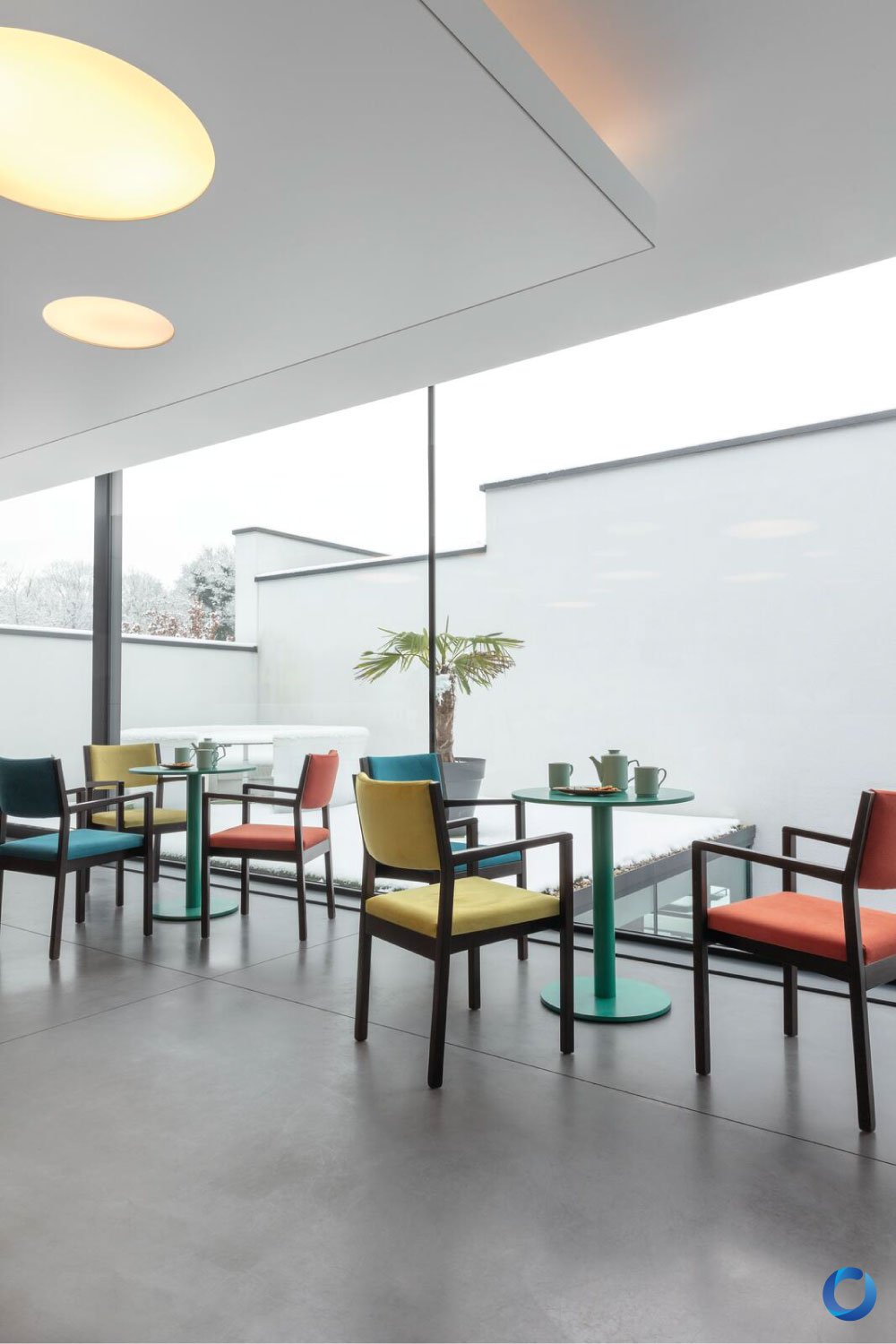 Modern café with colorful chairs, glass windows, and minimalist decor. Combo Collection