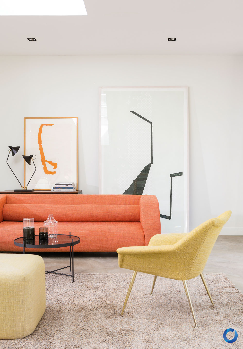 Modern living room with vibrant orange sofa and yellow chair. Gent Collection
