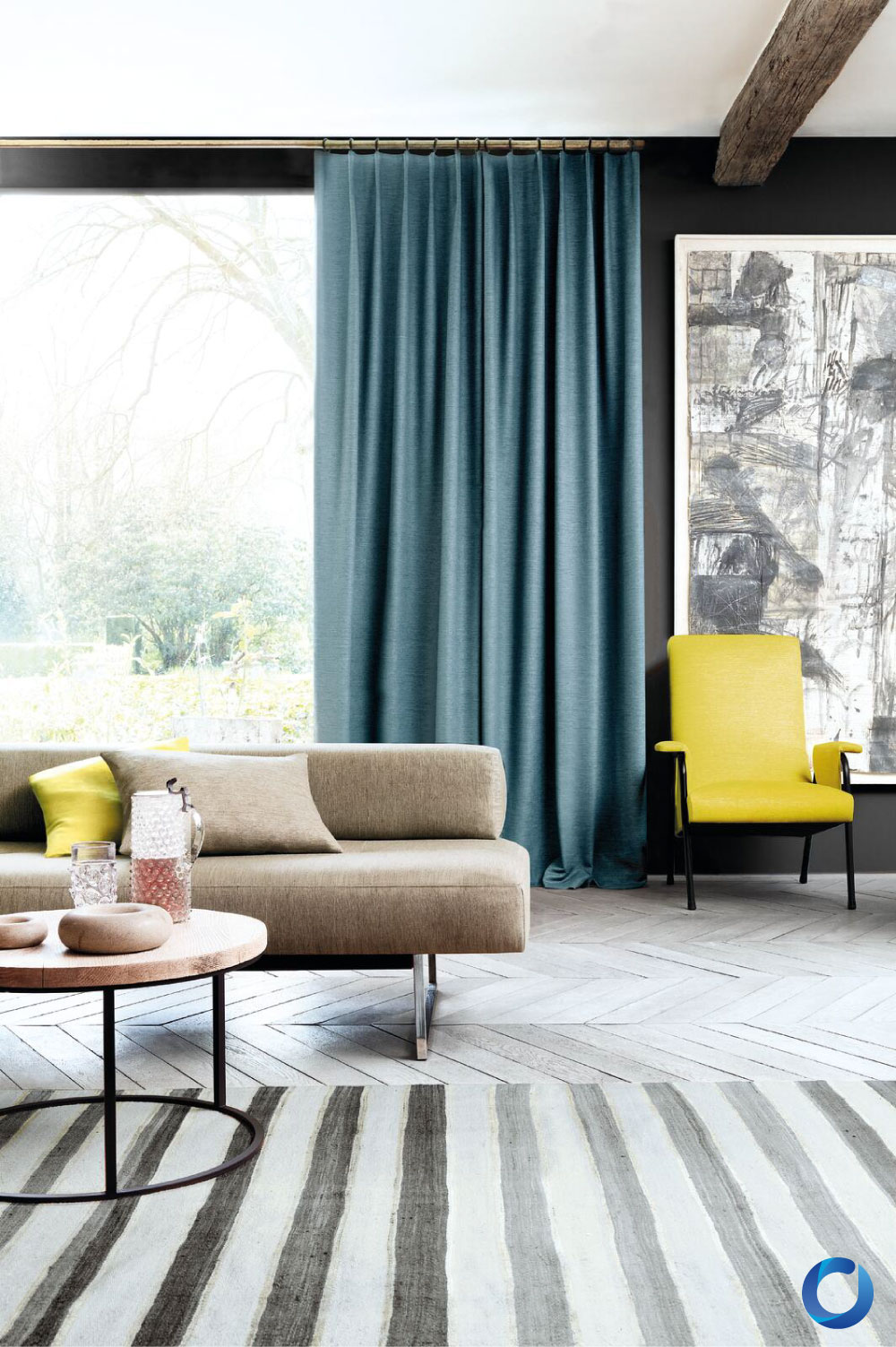 Modern living room with blue curtains, neutral sofa, and yellow chair. Provence Collection