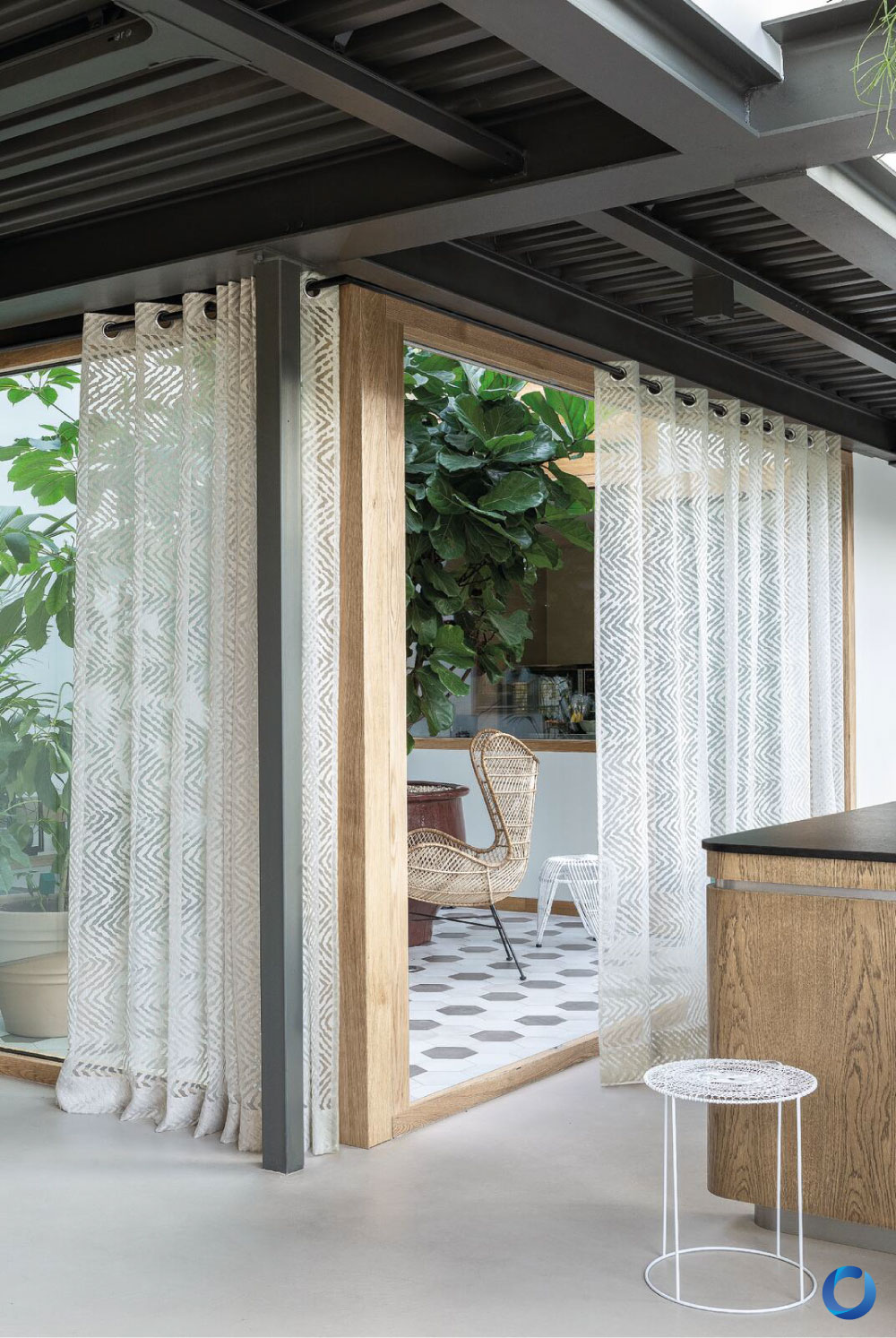 Sheer patterned curtains in modern indoor-outdoor living space. Grandland Collection