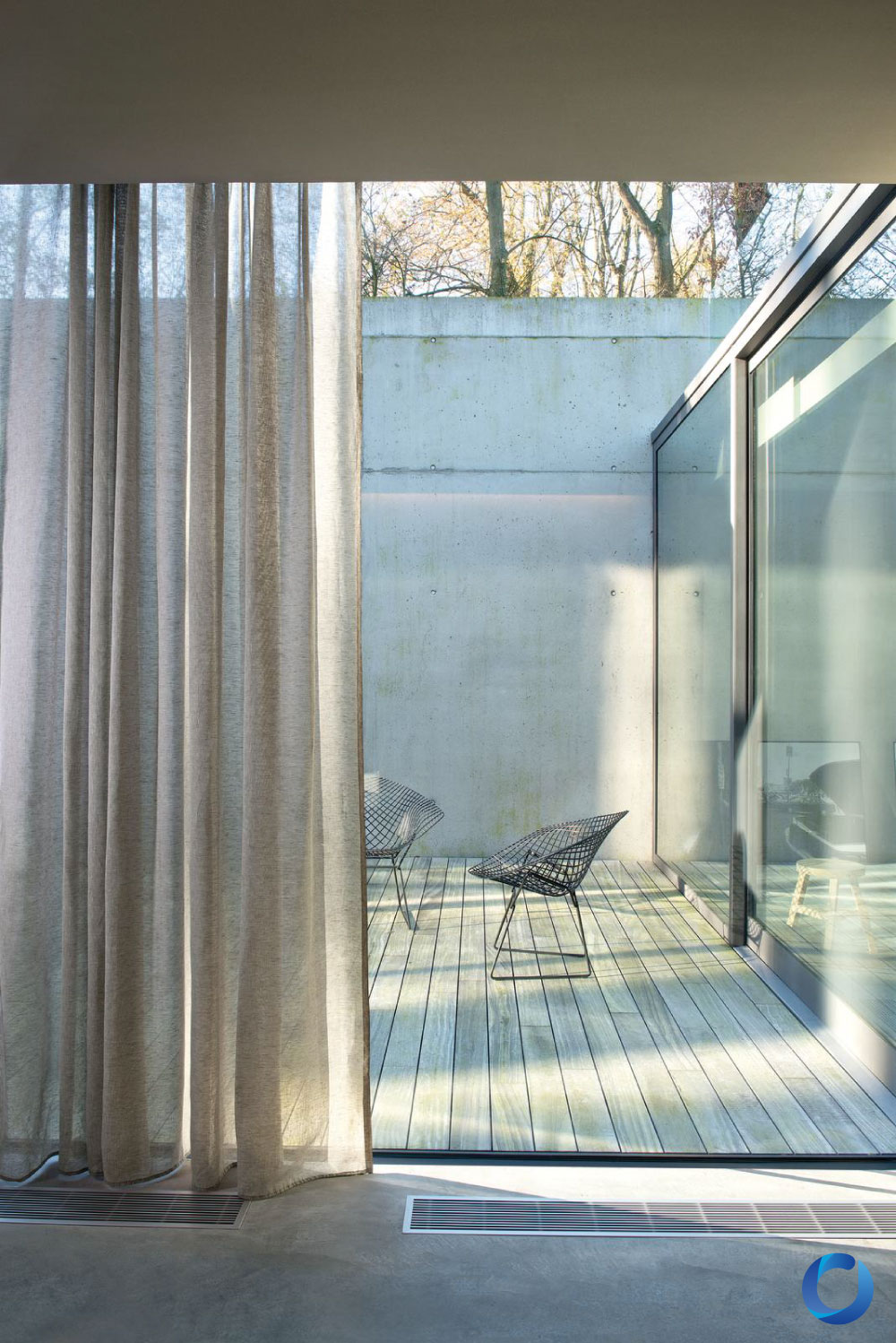 Modern glass patio with floor-to-ceiling sheer curtains. Day Break Collection