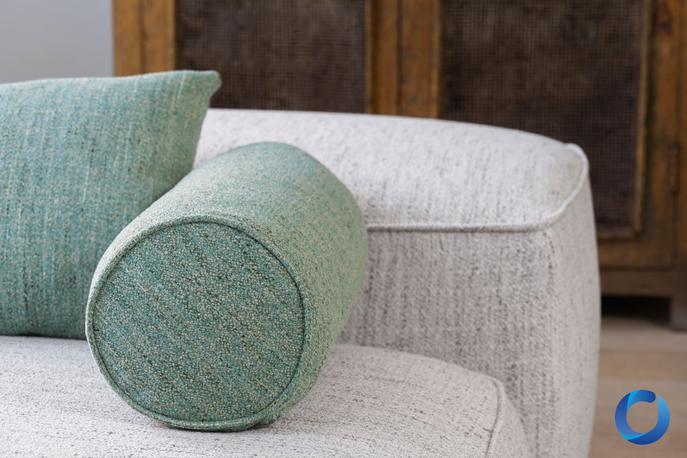 Textured green and grey upholstery fabric with bolster cushion. Mingle Mangle Collection