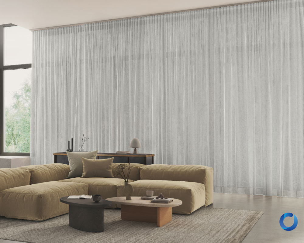 Spacious living room with sheer white curtains and sofa. Statement Collection