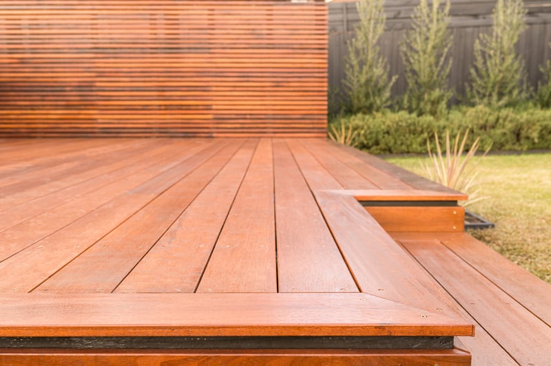 Edge of deck with step with garden lawn in background