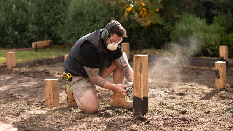 A person is cutting the stumps to the required height